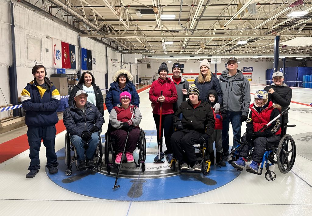 A group photo of GBAS Adaptive Curling, some in wheelchairs and some standing