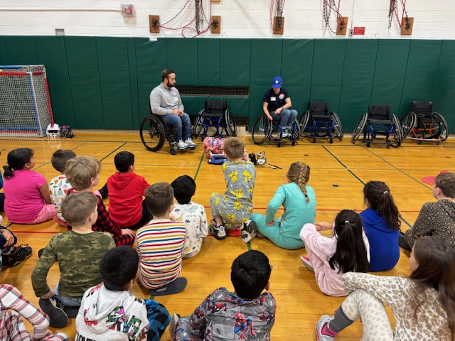 A group of students listen to GBAS volunteers as they demo equipment.